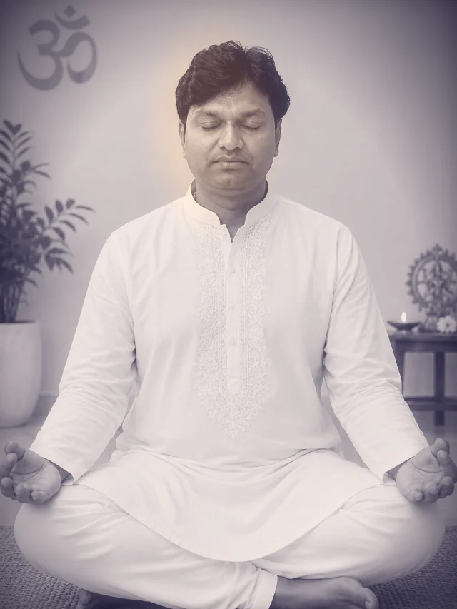 Dr. Hari Krishna seated cross-legged in meditation, eyes closed, palms resting open on his knees